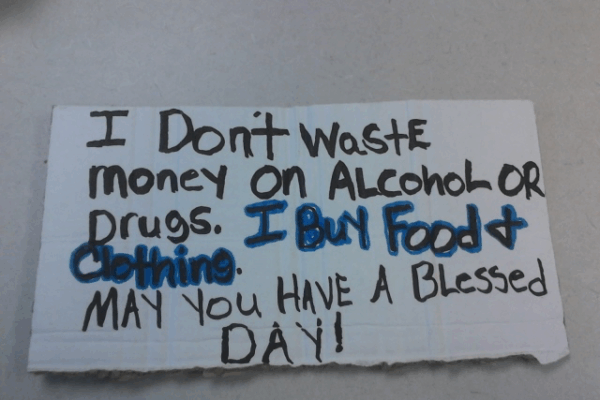 Reads: I don't waste money on alcohol or drugs. I buy food and clothing. May you have a blessed day!