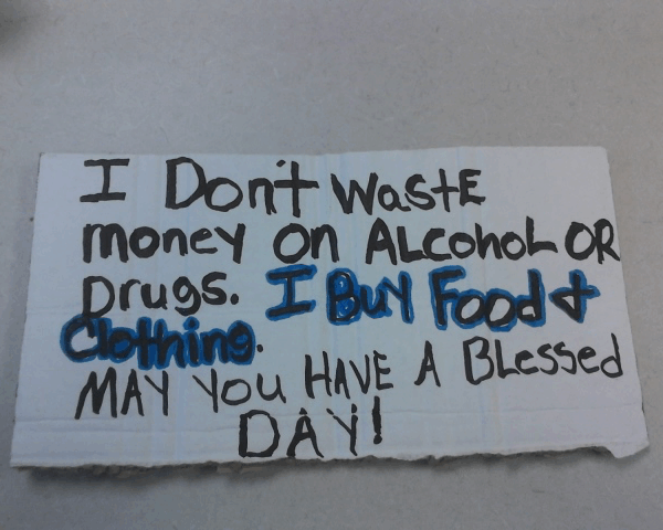 Reads: I don't waste money on alcohol or drugs. I buy food and clothing. May you have a blessed day!