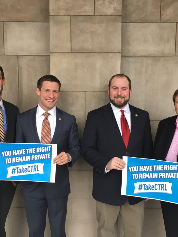 Sen. Tyson Larson, Sen. Adam Morefeld, Sen. Matt Hansen, and Sen. Laura Ebke with signs saying "you have the right to remain private. #TakeCTRL"