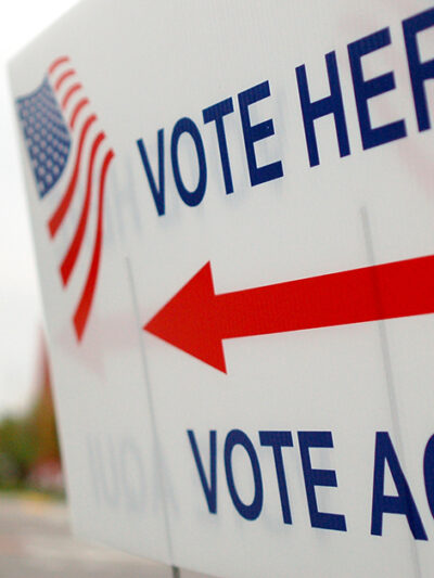 Sign near a polling place saying "Vote Here" and "Vote Aqui"