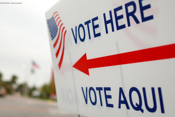 Sign near a polling place saying "Vote Here" and "Vote Aqui"