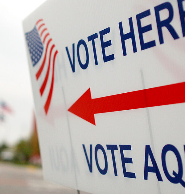 Sign near a polling place saying "Vote Here" and "Vote Aqui"