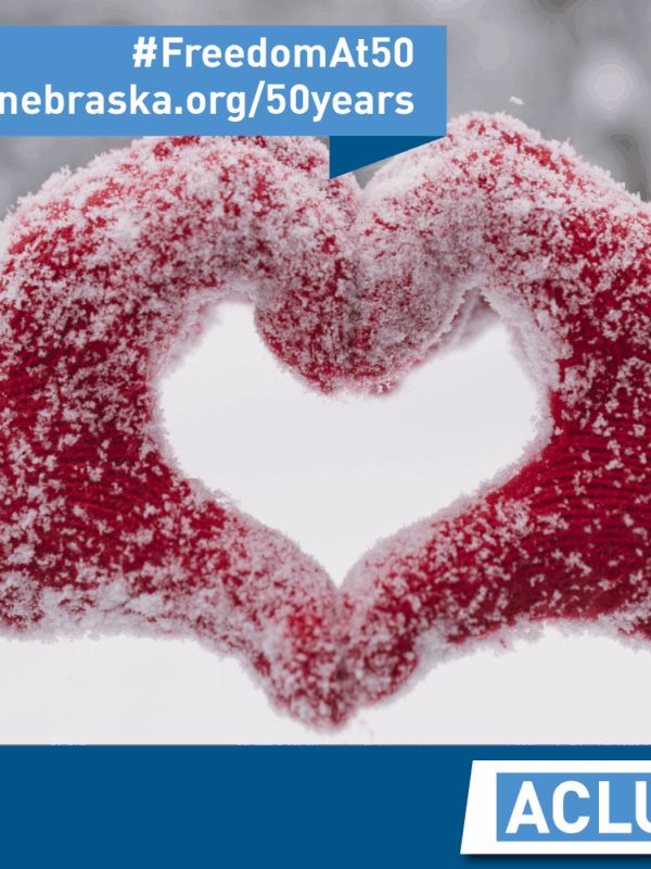 Photo of red gloovers, govered with snow, forming a heart
