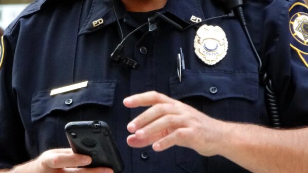 Law enforcement officer with a cell phone