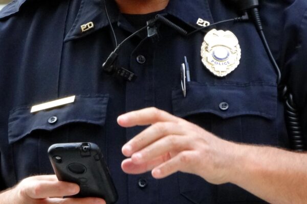 Law enforcement officer with a cell phone