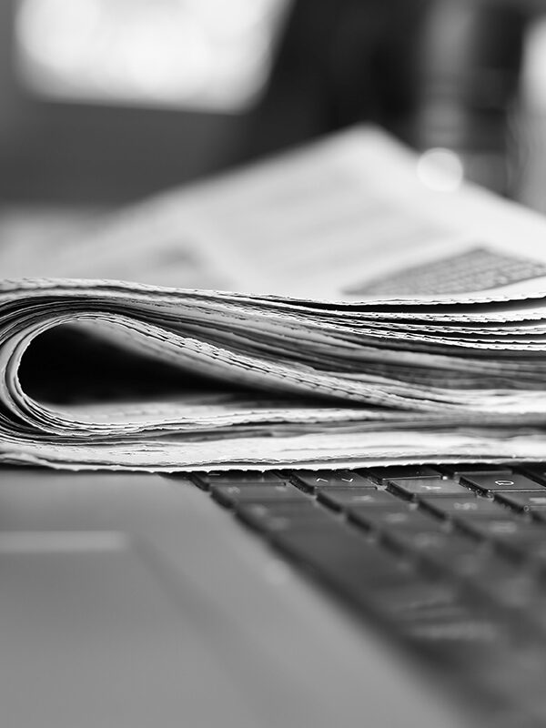 photo of a newspaper on a laptop