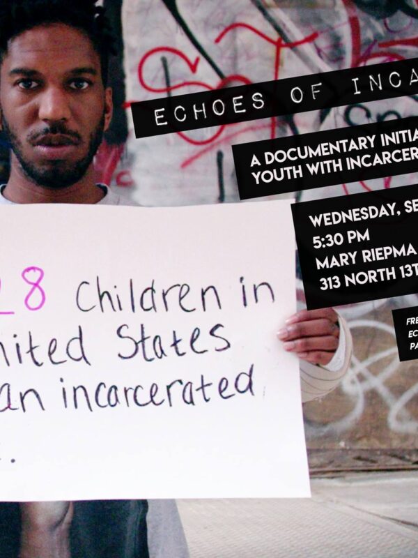 Photo of Man Holding Sign saying "1 in 28 children in the US has an incarcerated parent."