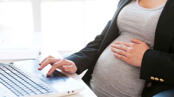 Pregnant woman at desk
