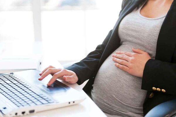 Pregnant woman at desk