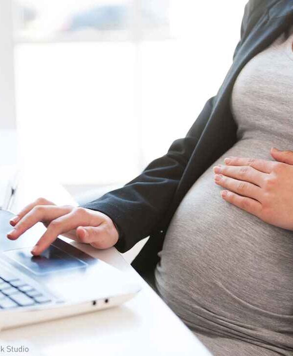 Pregnant woman at desk