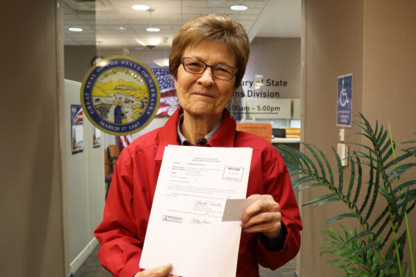 Campaign co-chair and former State Sen. DiAnna Schimek displays a copy of filed paperwork outside of the Nebraska Secretary of State’s Office.