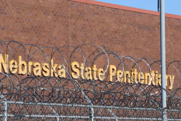 An image showing barbed wire in front of the Nebraska State Penitentiary.