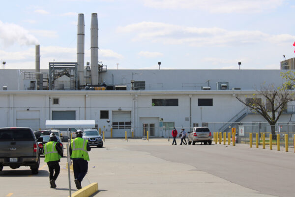 Two workers walk toward the Tyson Foods processing plant in Dakota City, Nebraska.