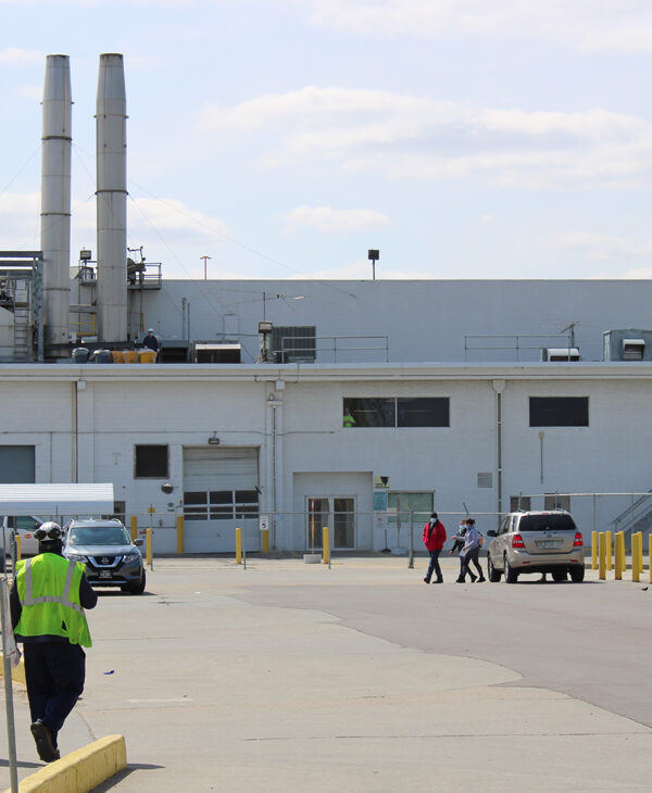Two workers walk toward the Tyson Foods processing plant in Dakota City, Nebraska.