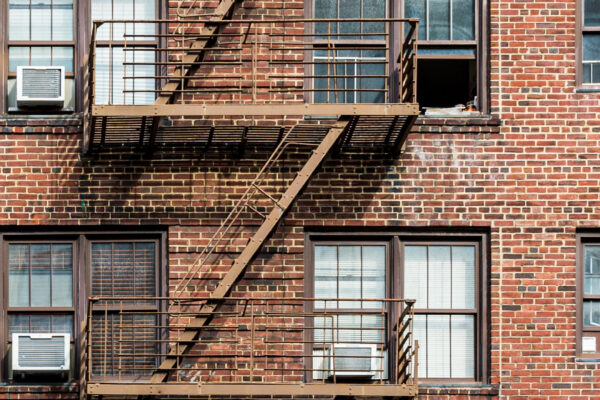 A photograph of a brick apartment building.