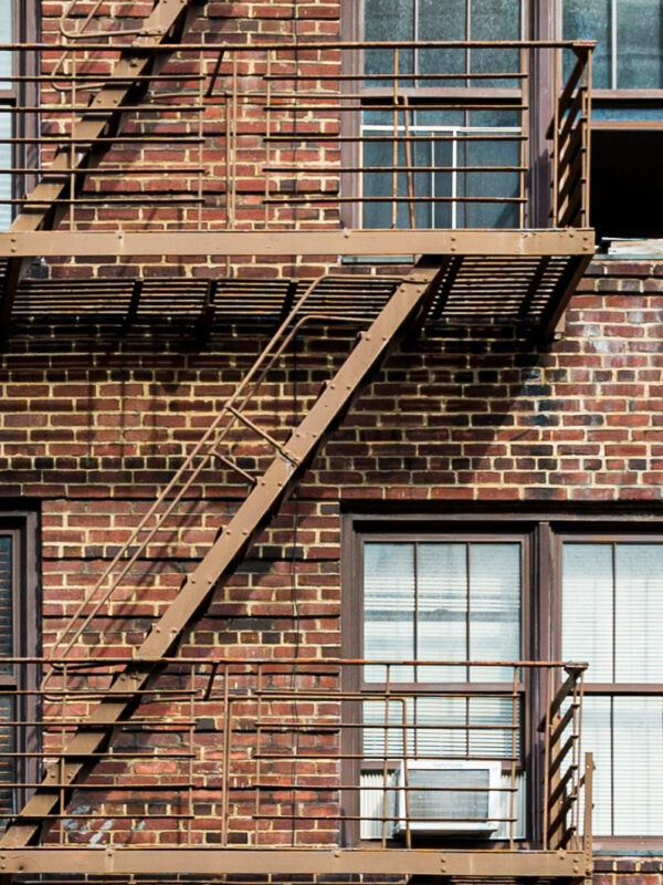 A photograph of a brick apartment building.