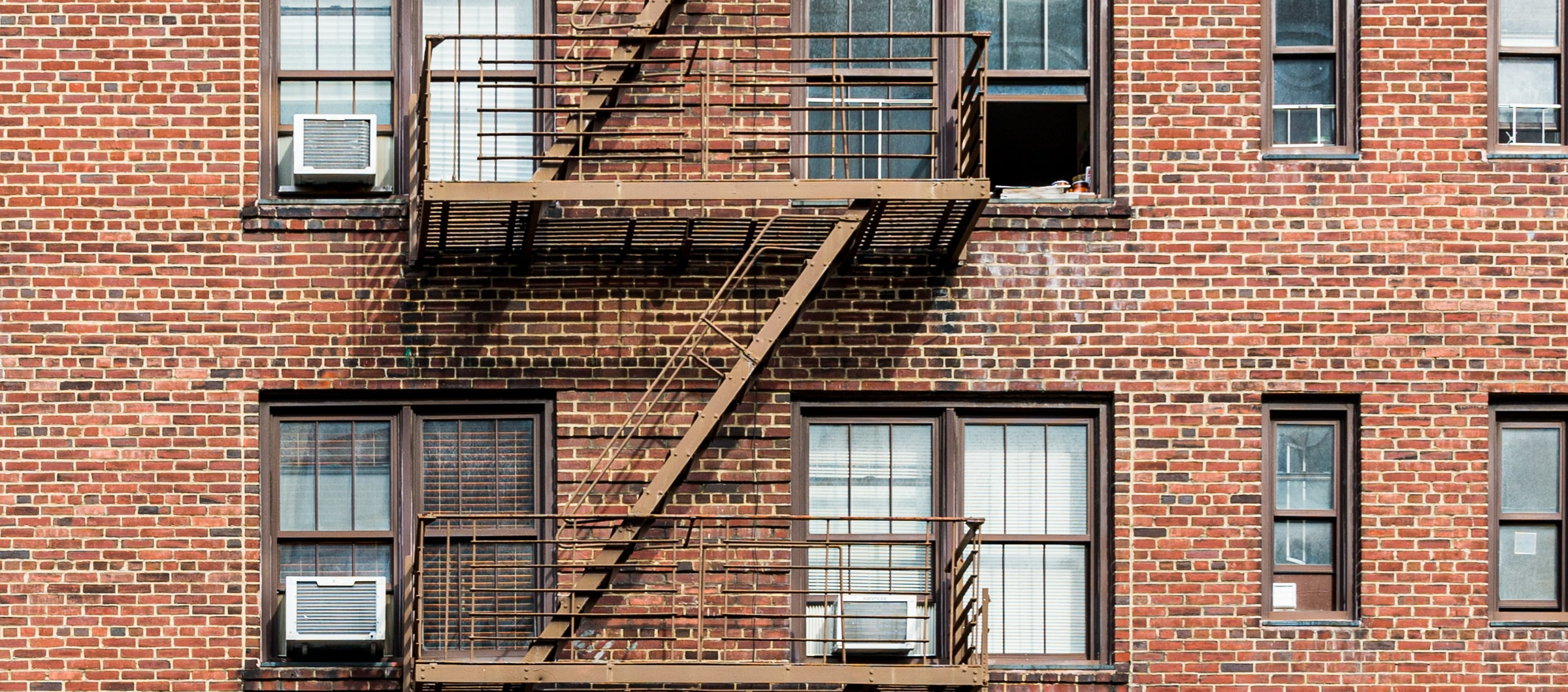 A photograph of a brick apartment building.