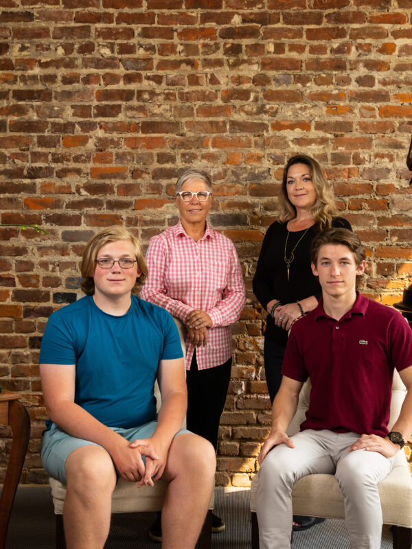 Erin Porterfield and Kristin Williams stand behind their sons in a group photo.