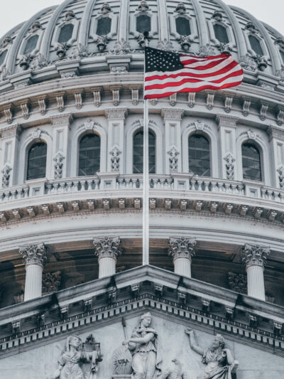 The American flag flies over the U.S. Capitol.
