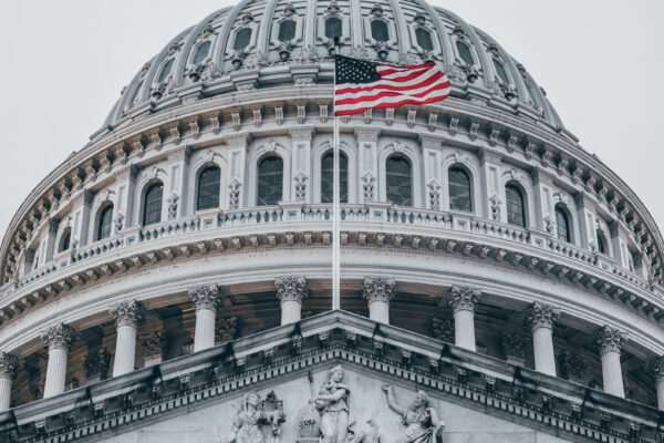 The American flag flies over the U.S. Capitol.
