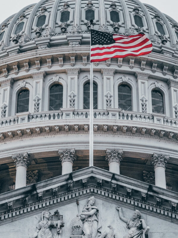 The American flag flies over the U.S. Capitol.