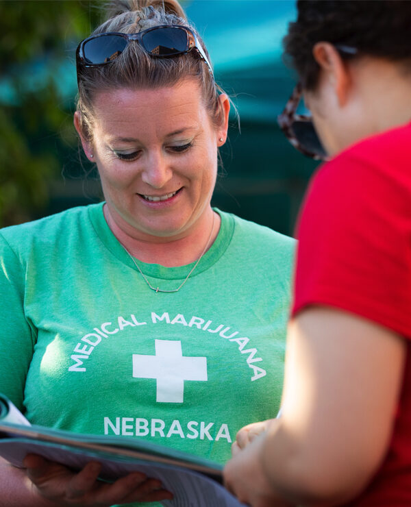 Campaign volunteer Nicole Hochstein collects a petition signature in Omaha.