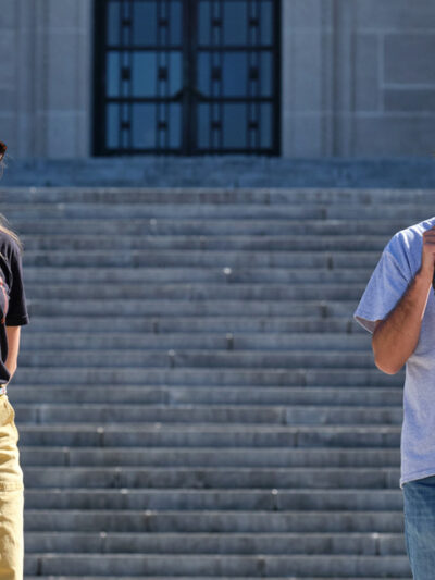 Erin Poor and Kevin Abourezk speak at a solidarity rally