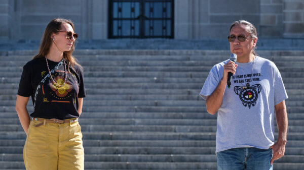 Erin Poor and Kevin Abourezk speak at a solidarity rally