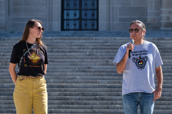 Erin Poor and Kevin Abourezk speak at a solidarity rally