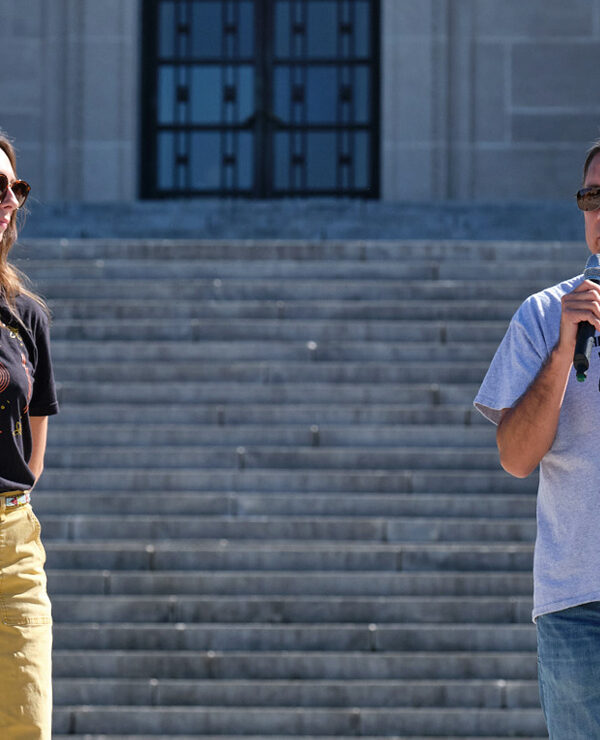 Erin Poor and Kevin Abourezk speak at a solidarity rally