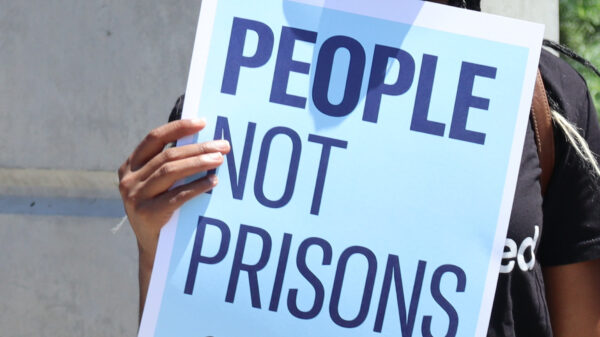 A poster reads "people not prisons"