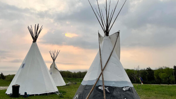 Three tipis stand at the Niskíthe Prayer Camp.