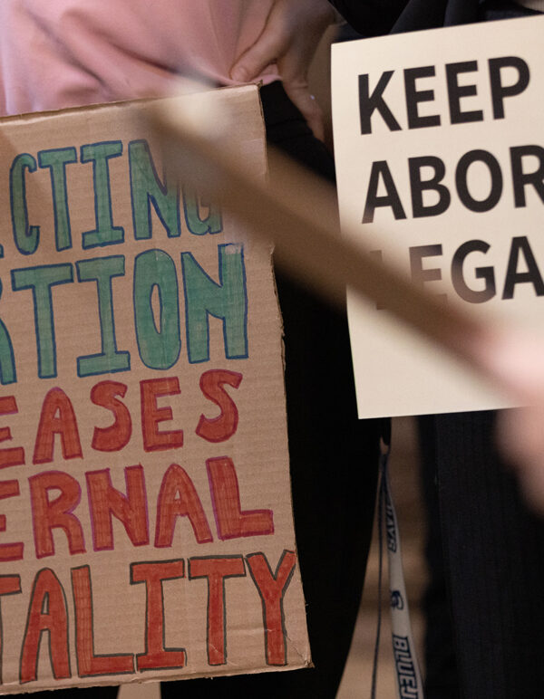 Nebraskans hold signs in support of abortion rights ahead of a committee hearing on six-week abortion ban LB 626.