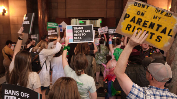 Nebraskans gather to urge senators to reject a bill combing both new restrictions on abortion and on health care for trans youth. One holds a sign reading "Don't tread on my parental rights."