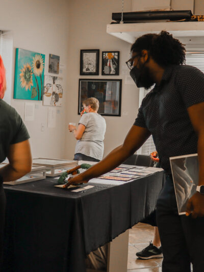 Attendees and organizers view art at the 2022 Art from the Inside exhibit.
