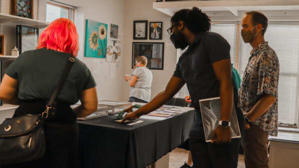 Attendees and organizers view art at the 2022 Art from the Inside exhibit.