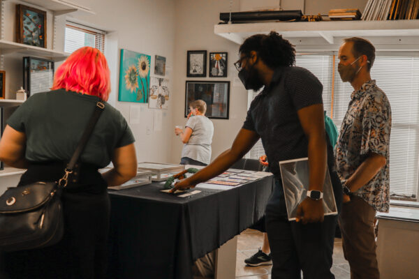 Attendees and organizers view art at the 2022 Art from the Inside exhibit.