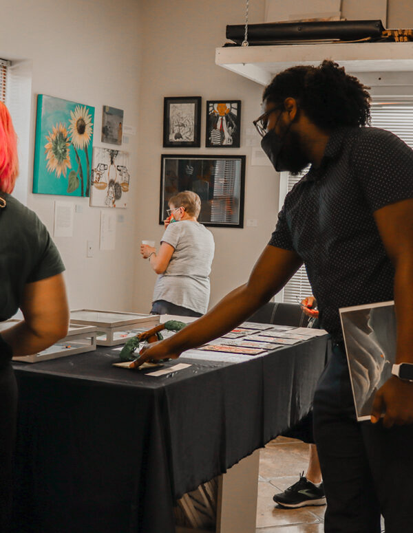 Attendees and organizers view art at the 2022 Art from the Inside exhibit.