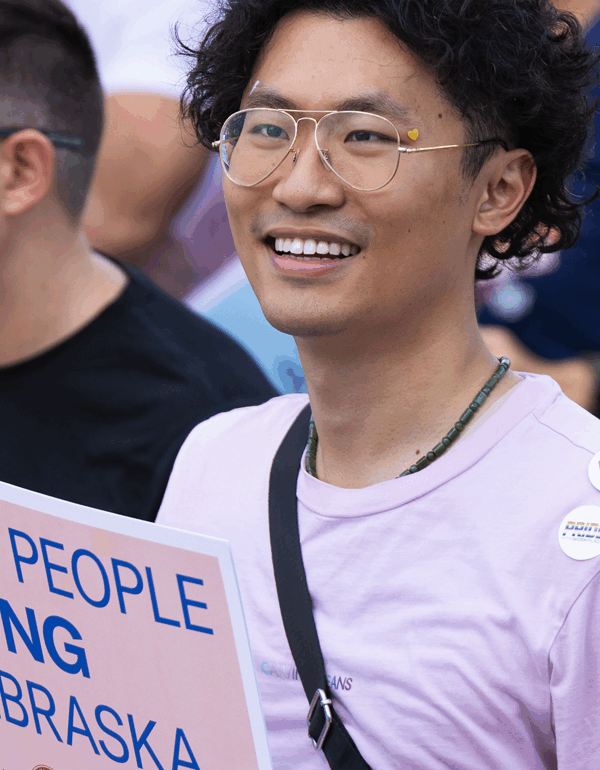 A Nebraskan holds a sign reading "Trans people belong in Nebraska" at a rally outside the Nebraska State Capitol. Photo by Rebecca Gratz for the ACLU of Nebraska.