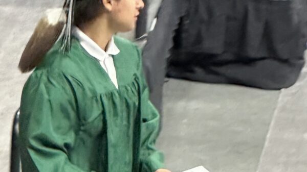 A young man walks off the stage during his high school graduation ceremony in Omaha.