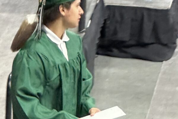 A young man walks off the stage during his high school graduation ceremony in Omaha.