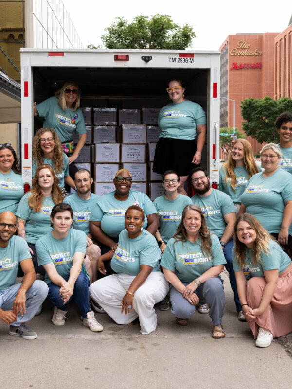 Coalition members, including several ACLU of Nebraska staff members, pose in front of a U-Haul truck holding more than 207,000 signatures supporting abortion rights in Nebraska.