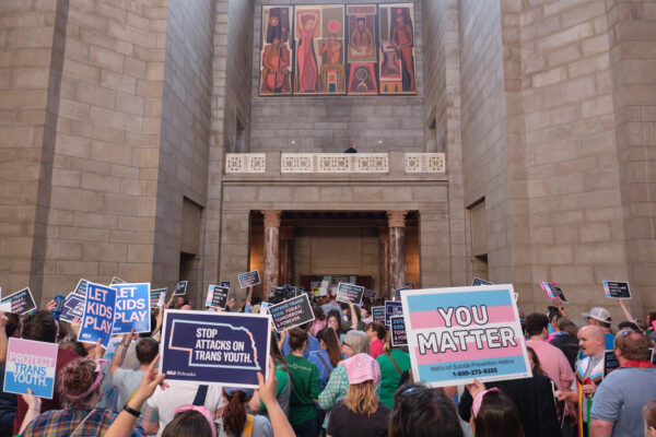 Supporters of trans youth gather at the Nebraska state capitol with signs in support to trans youth