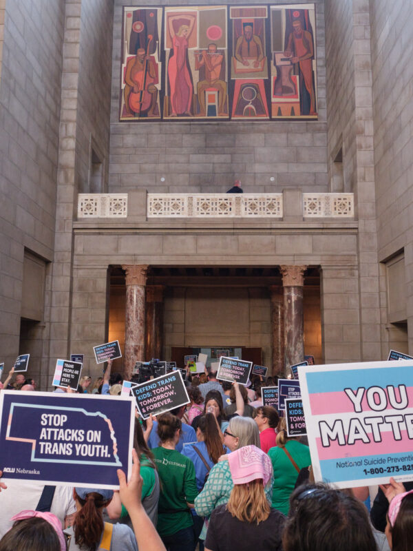 Supporters of trans youth gather at the Nebraska state capitol with signs in support to trans youth
