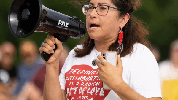 A woman speaks at an Omaha rally following the fall of Roe v Wade.