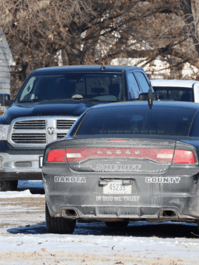 An image of a Dakota County Sheriff's office cruiser. The back reads "In God We Trust"
