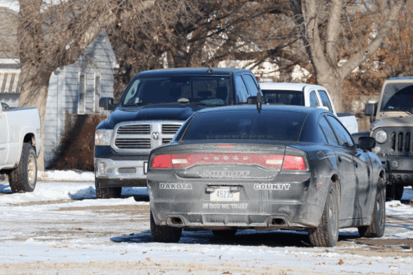 An image of a Dakota County Sheriff's office cruiser. The back reads "In God We Trust"