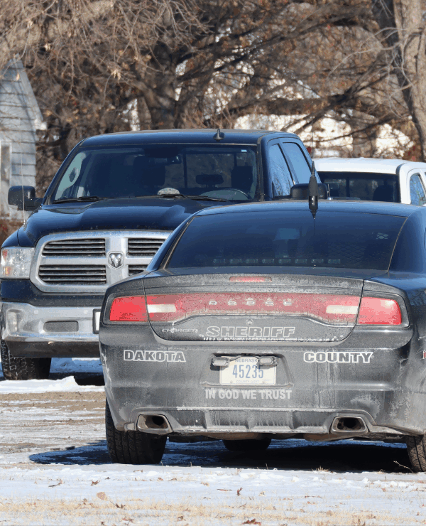 An image of a Dakota County Sheriff's office cruiser. The back reads "In God We Trust"