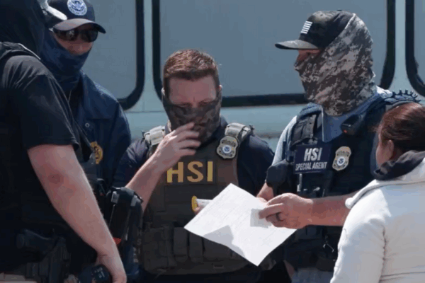 ICE agents talk during their June 10 raid of Glenn Valley Foods. This image is a screencap of video released by ICE.