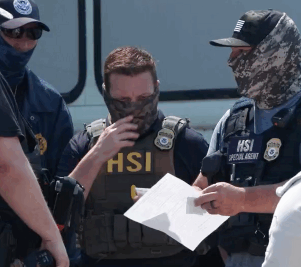 ICE agents talk during their June 10 raid of Glenn Valley Foods. This image is a screencap of video released by ICE.